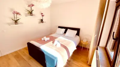 a small bedroom with a bed with flowers on it at La douce Rive in Esneux