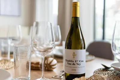 a bottle of wine sitting on a table with glasses at Saint Pablo Boutique Apt I 3BR, Grote Markt, City Center, Near Station in Hasselt