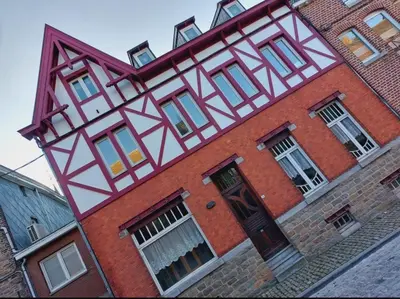 a red brick building with aandanandanandanandan at Ô Colombages in Les Biolles
