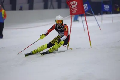 a man is skiing down a snow covered slope at Huize Clementina in Peer