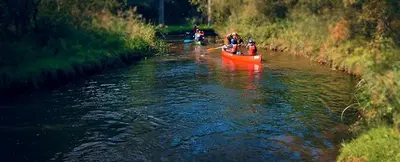 a group of people in a boat on a river at Huize Clementina in Peer