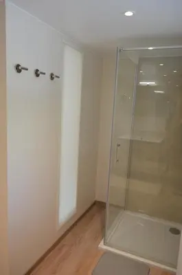 a glass shower in a room with a wooden floor at Holiday Home Mooi-Gemmenich in Plombières
