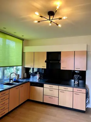 a kitchen with black counter tops and a ceiling fan at R&M in Kortessem