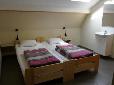 a bedroom with a bed with two pillows on it at Schophemmerhoeve in Voeren