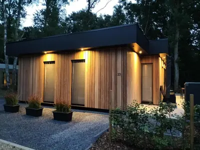 a small house with a black roof at Theressa - Free Wifi en Netflix in Zutendaal