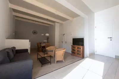 a living room with a couch and a table at Vakantiewoningen Pomona in Heers