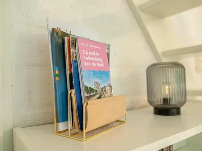 a book holder sitting on a shelf with books at Boshuisje Rekem - Boris in Lanaken