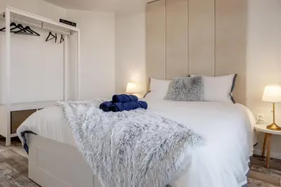 a bedroom with a white bed with a blanket on it at Marshmallow in Liège