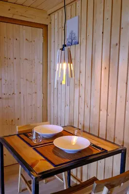 a wooden table with two white plates on it at La tanière in Chaudfontaine