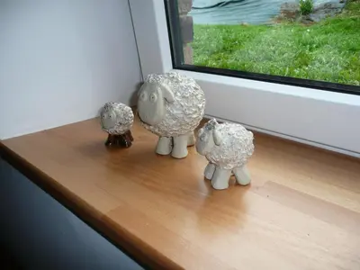 three sheep figurines sitting on a window sill at B&B La ferme de Berwausault in Herve