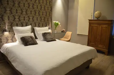 a bedroom with a large white bed with two pillows at B&B N°5 in Liège