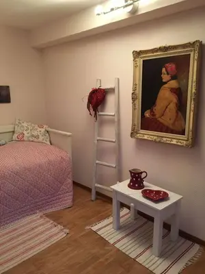 a room with a painting on the wall and a table at Haus Dany in Raeren