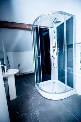 a glass shower in a bathroom with a sink at Superbe chambre sur liège in Liège