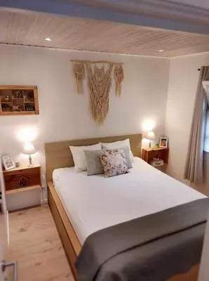a bedroom with a large white bed with two lamps at Isidaura in Zutendaal