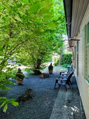 a row of benches sitting next to a building with trees at Isidaura in Zutendaal