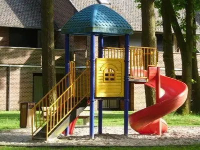 a childrens playground with a slide and a slideintend at Hengelhoef Acacia 3 in Drijhoeven