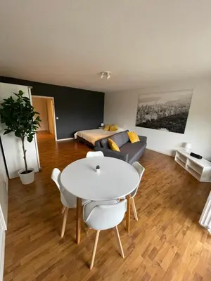a living room with a table and a couch at Alexis's loft in Liège