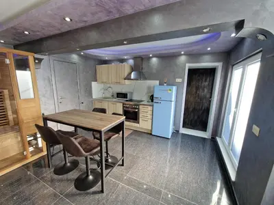 a kitchen with a wooden table and a blue refrigerator at Tendresse - Espace Détente Ensival in Verviers