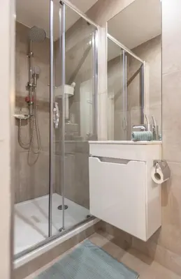 a bathroom with a shower with a sink and a mirror at La Chambre Suspendue by Maison Brasseurs d'Etoiles - Appartement 2 personnes in Liège