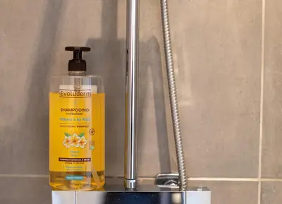 a bottle of mouthwash sitting next to a sink at Le Studio Compostelle by Maison Brasseurs d'Etoiles - Appartement 2 personnes in Liège