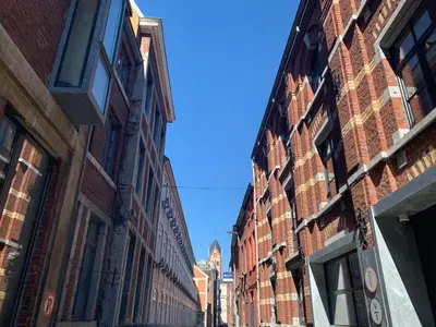an alley between brick buildings on a city street at Le Loft Nautilus by Maison Brasseurs d'Etoiles in Liège