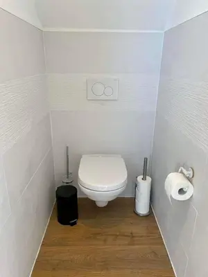 a small bathroom with a toilet and two rolls of toilet paper at Au cœur de l'Ardenne Bleue - Studio avec piscine in Baelen