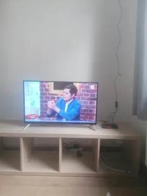 a television sitting on a wooden table in a room at Studio régence in Liège
