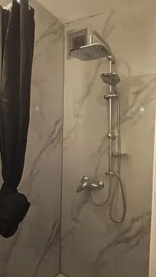 a shower with a shower head in a bathroom at Studio régence in Liège