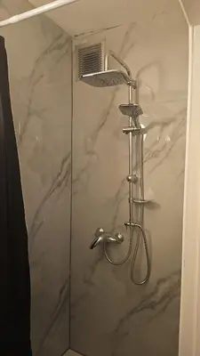 a shower with a shower head in a bathroom at Studio régence in Liège