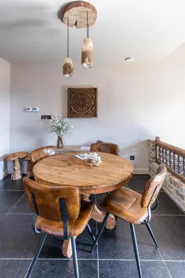 a dining room with a wooden table and chairs at guesthouse Kamiele bij Lavendine Pure in Genk