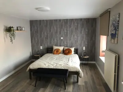 a bedroom with a bed with two pillows on it at Hoeve Terwinghe in Gingelom