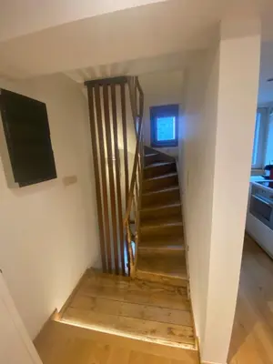 a staircase leading up to a room with a television at TRIPLEX NEUVICE in Liège