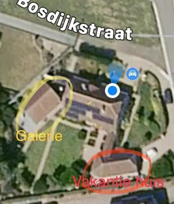 a map of a building with a blue circle and a building at Vakantiehuis de wereldburger Worldcitizen in Oudsbergen