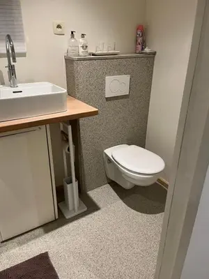 a bathroom with a toilet and a sink at Vakantiehuis de wereldburger Worldcitizen in Oudsbergen