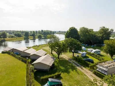 an aerial view of a group of tents next to a river at Camping de Boomgaard in Maaseik