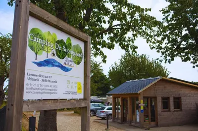 a sign in front of a small building at Camping de Boomgaard in Maaseik