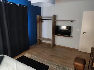 a room with a bed and a tv in a room at Gîte La Renéade in Foyr