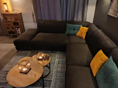 a living room with a couch and a table at Gîte La Renéade in Foyr