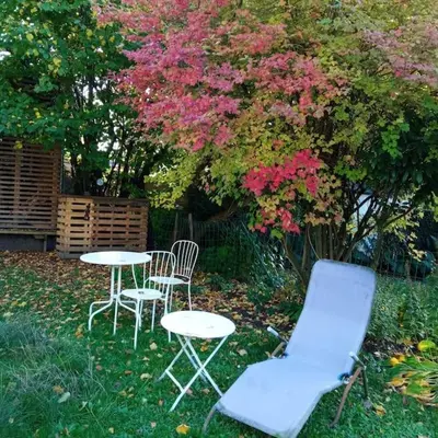 two chairs and a table and chairs in a yard at Loft, parking privé, terrasse, entrée indépendante in Liège