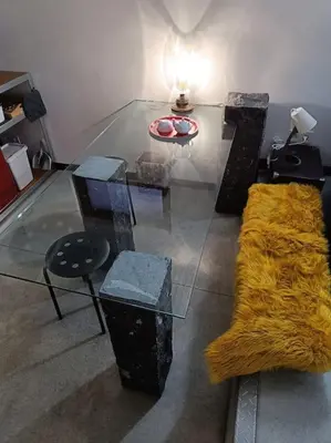 a living room with a glass table and a couch at Loft, parking privé, terrasse, entrée indépendante in Liège