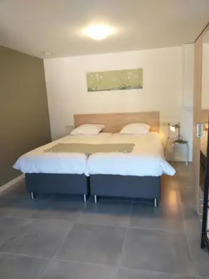 a bedroom with a large bed in a room at De Hoog Velden 14 in Pelt