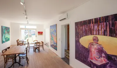 a room with a table and a large painting on the wall at Le Charbonnage in Genk