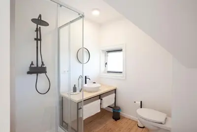 a bathroom with a sink and a glass shower at Le Charbonnage in Genk