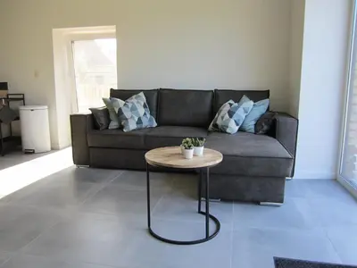 a living room with a couch and a table at De Hoog Velden 12 in Pelt