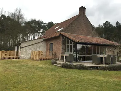 a large brick building with a large window at B&B De Paenhoeve in Eksel