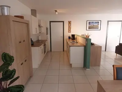 a kitchen with white cabinets and a tile floor at Kanaalzicht21 in Hasselt