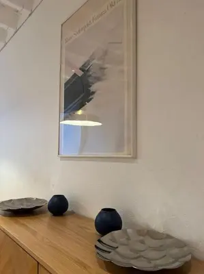 a table with two blue vases on top of it at Grand Triplex d'architecte en hypercentre in Liège