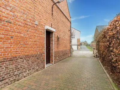a brick building with a door on the side of it at Zoutleeuw Home with Pool in Zoutleeuw