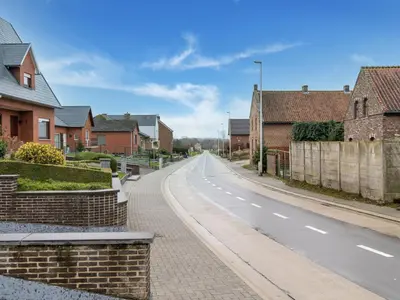 an empty street in a residential neighborhood with houses at Zoutleeuw Home with Pool in Zoutleeuw