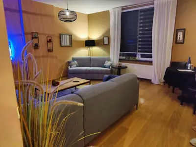a living room with a couch and a table at Leopold Appartementen & studio's in Sint-Truiden